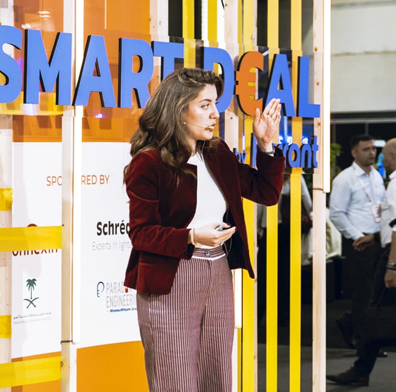 A female showing the number two with her fingers at the smart deal event